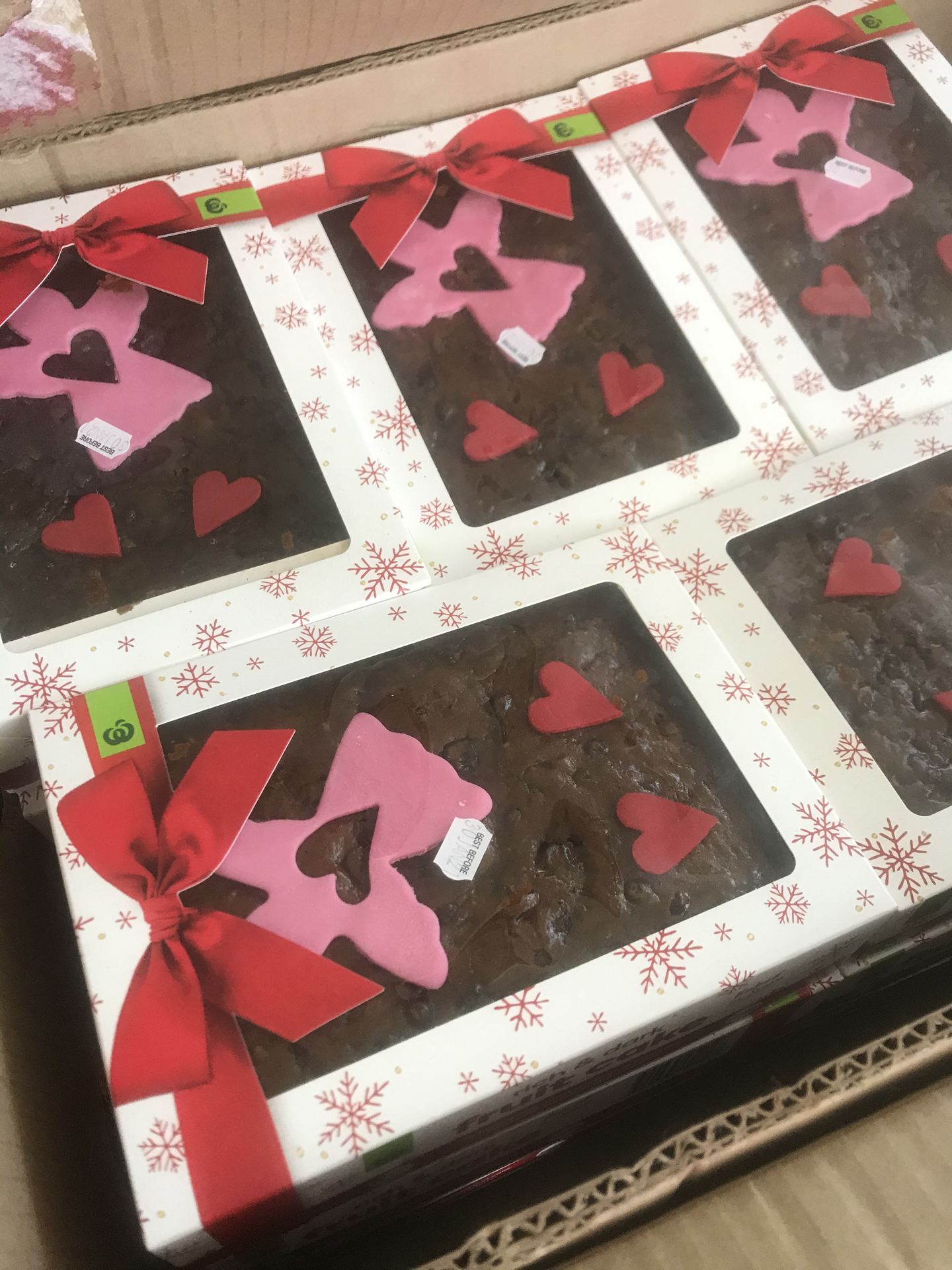 boxes of Christmas cakes with pink angels